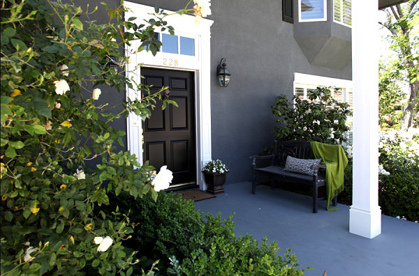 Outdoor bench with a pillow and a throw