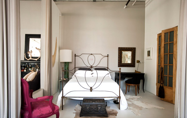 Pink chair adds a dash of color to this loft bedroom