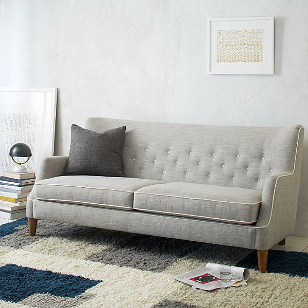 Tufted sofa with tapered legs