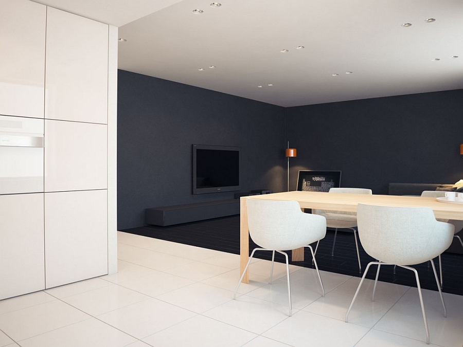 White dining table chairs stand out when placed in front of a black backdrop