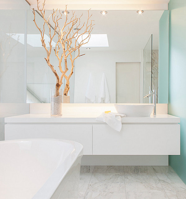 Branches add a dramatic touch to a crisp bathroom