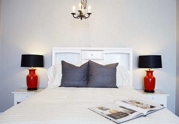 Charming black and red table lamps in a bedroom clad in white