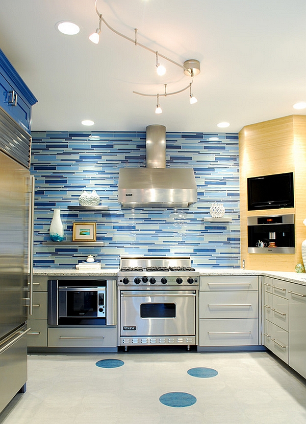 a bright kitchen with teal cabinets, mismatching tile backsplash