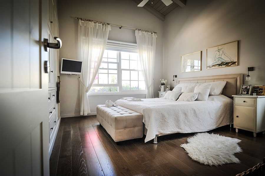 Comfy master bedroom design in white with wooden flooring