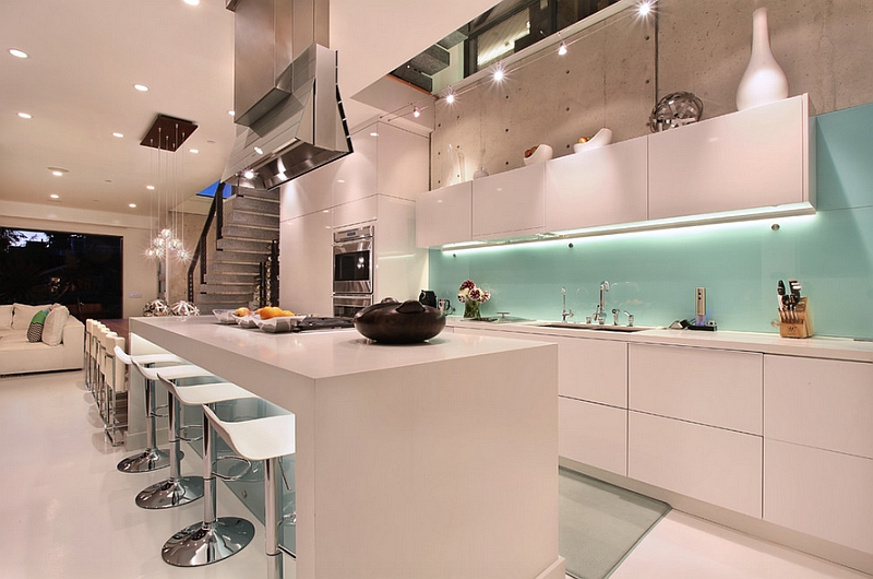 Cool glass painted backsplash in blue coupled with white cabinets