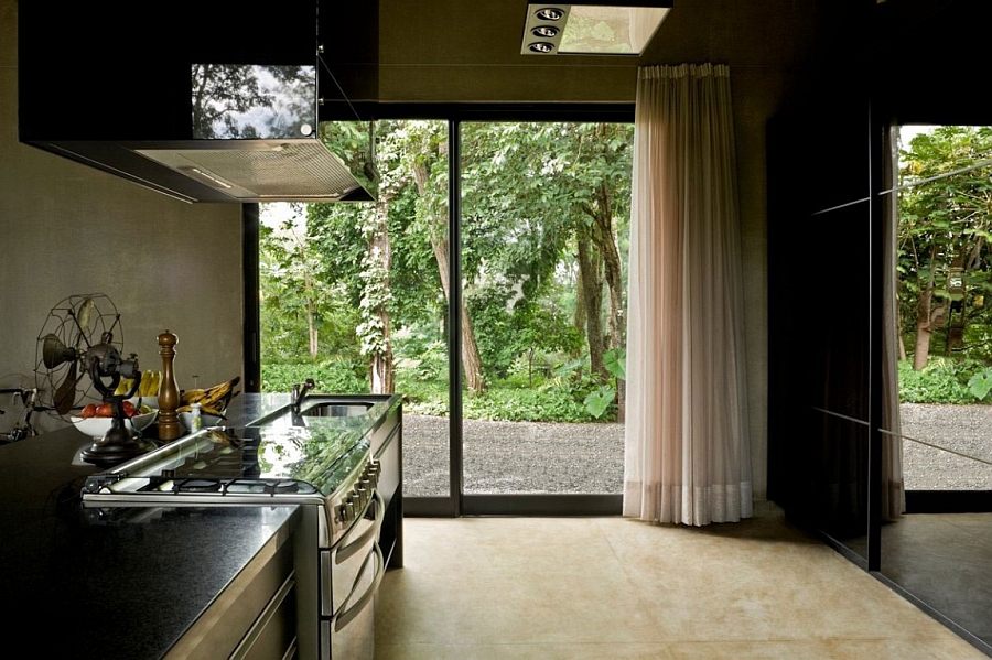 Exposed concrete lends the kitchen an industrial vibe