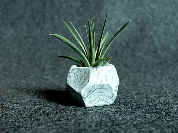 Faceted planter with a marbleized finish