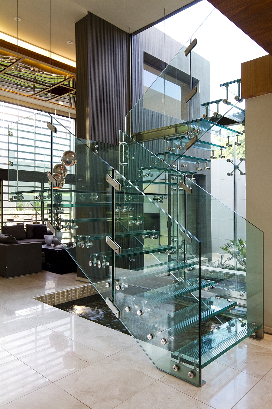 Glass staircase and indoor water feature at House Sed