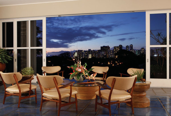 Hawaiian interior with tropical greenery and a rattan table