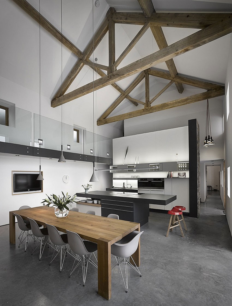 High ceilings with exposed wooden beams in renovated old English barn house