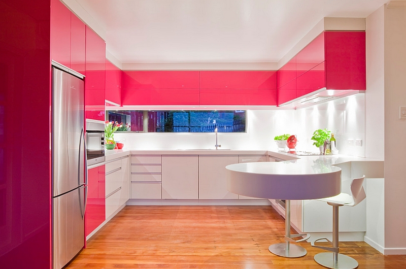 Hot pink lacquer cabinets in a white kitchen