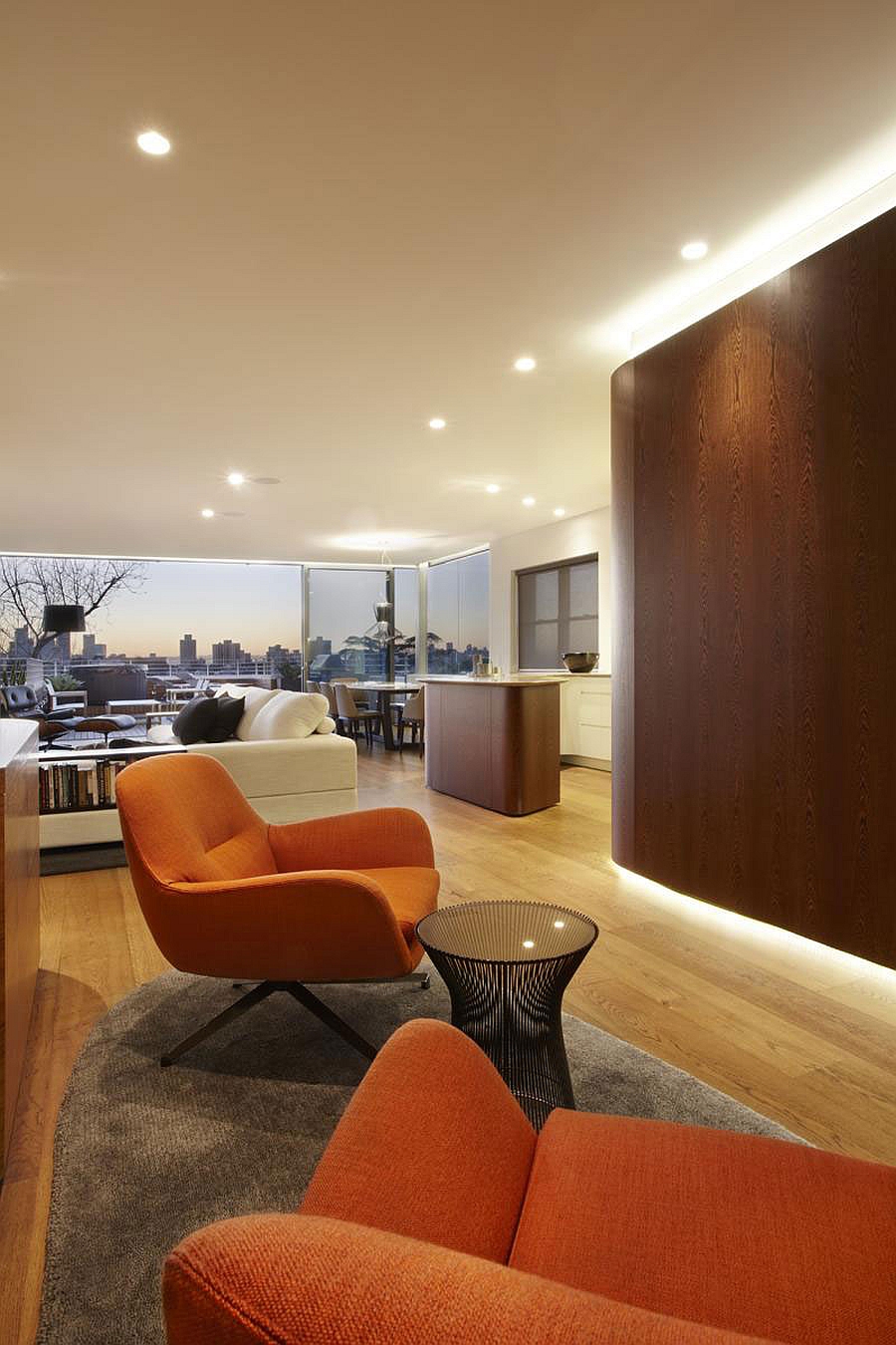 Lovely orange chairs add color to the sydney apartment