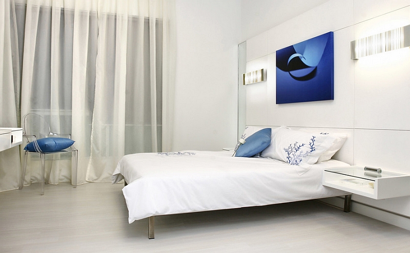 Minimalist bedroom in white with blue accents