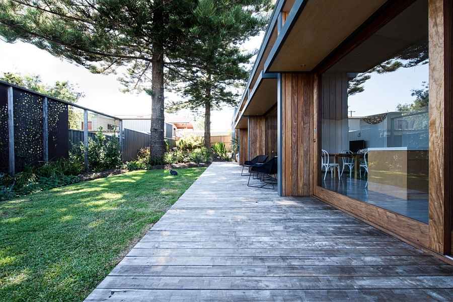 Simple wooden deck leading to the green backyard