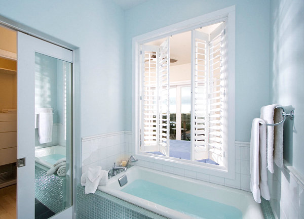 Sliding door within a powder blue bathroom