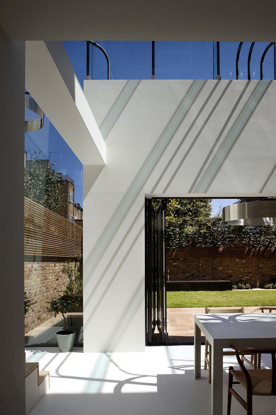 Stackable glass door connects teh indoor with the backyard