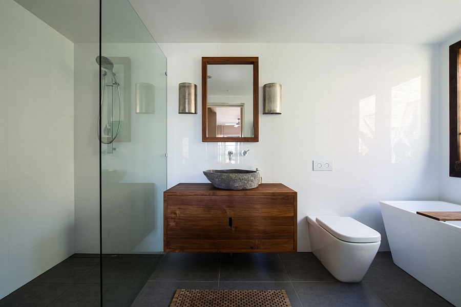 Stone sink stands out in the contemporary bathroom