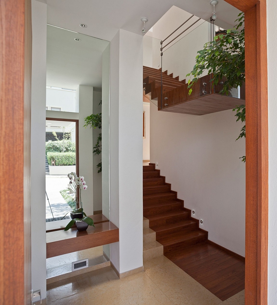 Wooden staircase with glass railing