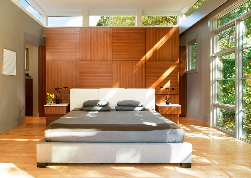 Wooden treatment behind headboard adds to the look of the modern bedroom