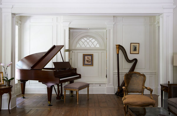 Georgian residence with harp in living room