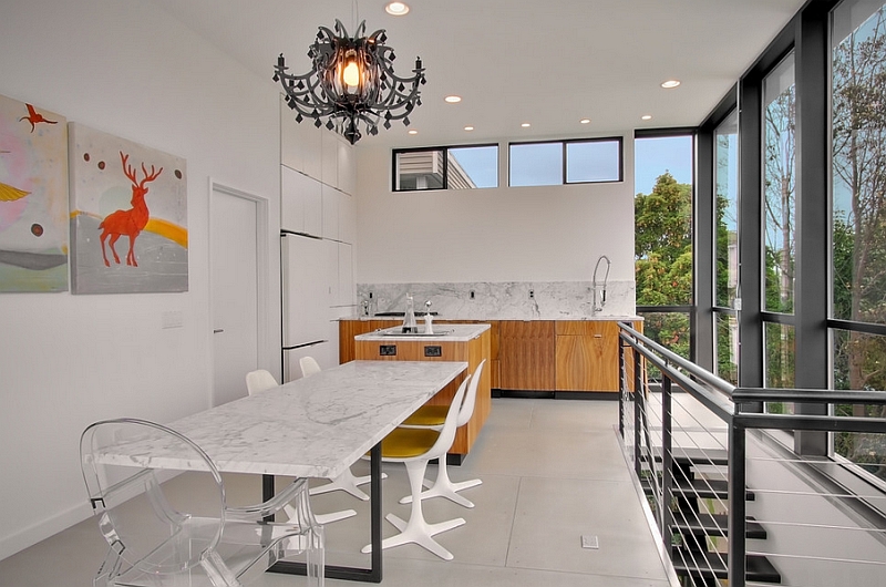 Acrylic chairs lend visual airiness to the dining space