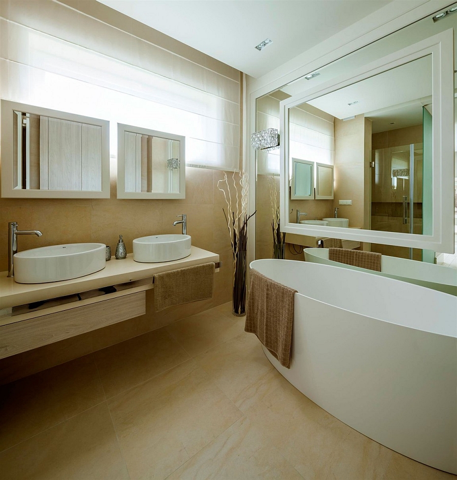 Beautiful modern bathroom in cream and white with floor vase