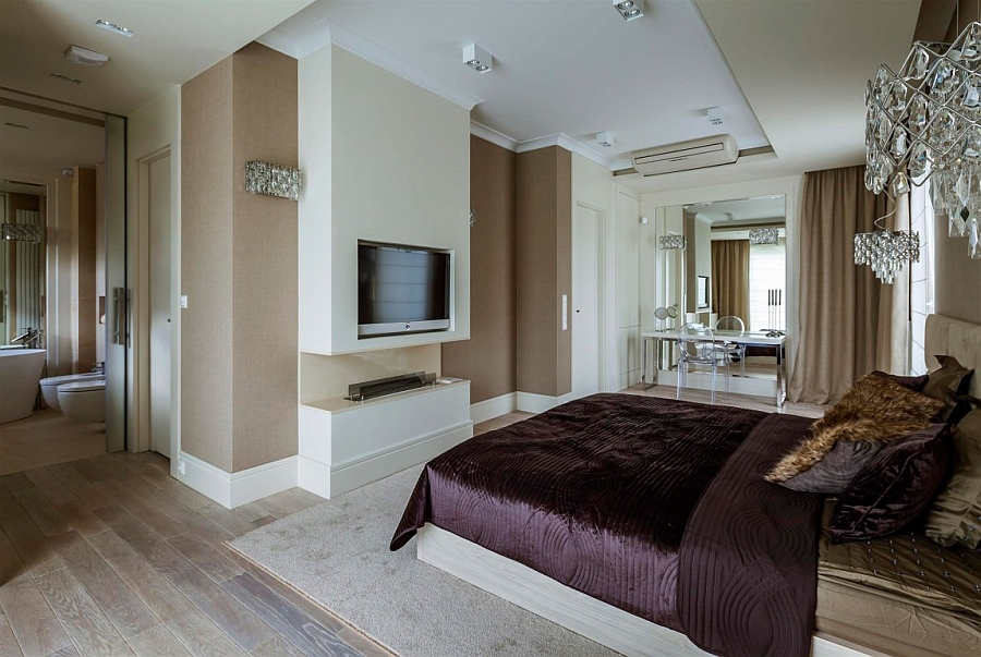 Bedroom TV above the sleek, contemporary fireplace