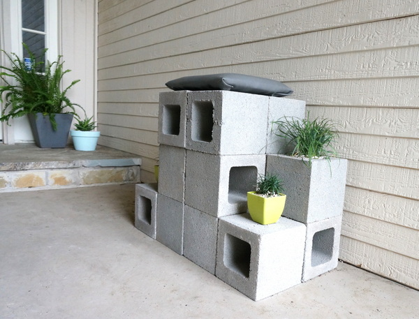 Cinder block throne with plants and a cushion