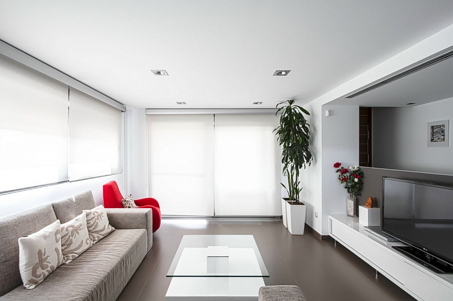 Contemporary living room in white and grey with red accents