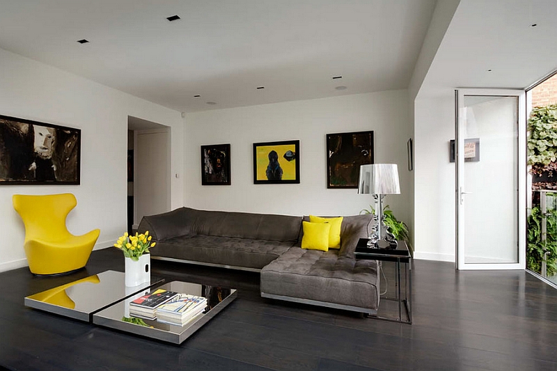 Contemporary living room with cool table lamp and pops of yellow accents