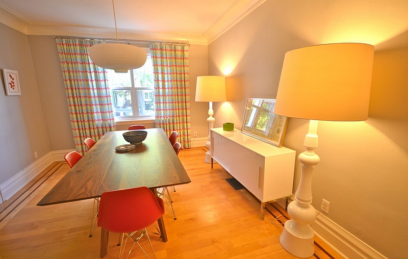 Eclectic and bright dining room with oversized floor lamps with yellow lampshades