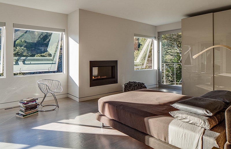 Exquisite master bedroom with a sleek fireplace