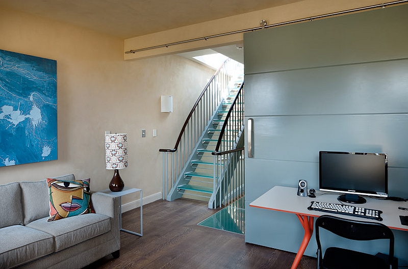 Family room with stylish glass stairway in the corner