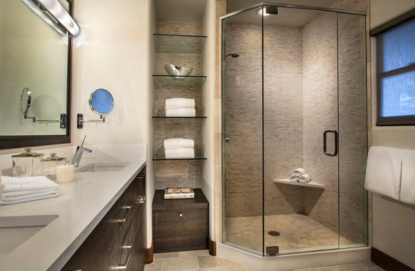 Glass shelves in a warm-toned bathroom