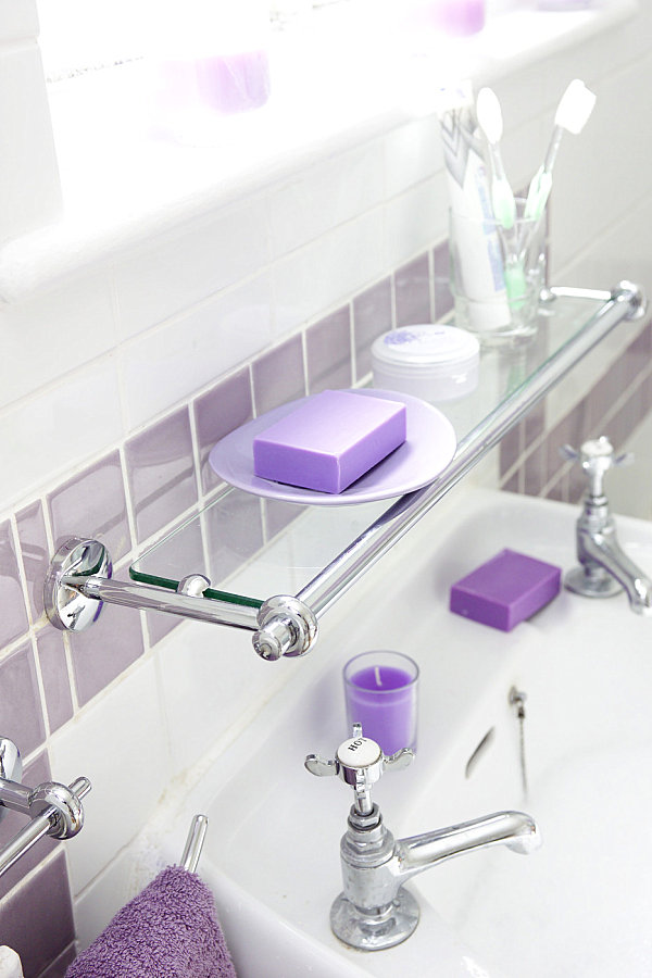 Glass shelving above a bathroom sink