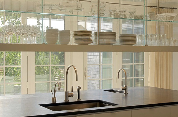 Glass shelving and cabinetry in a bright kitchen