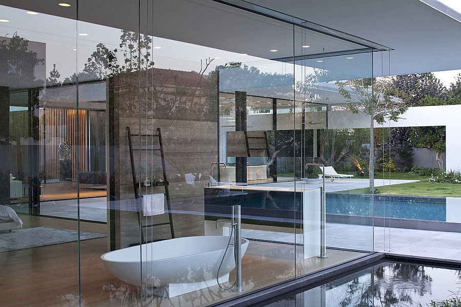 Glass walls surround the bathtub in the master bedroom