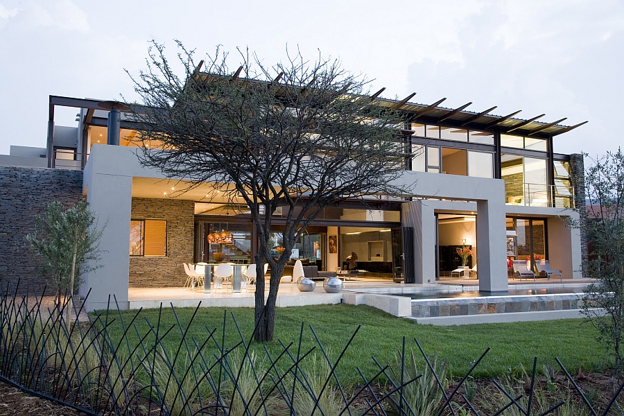 Large glass windows open up the house to the outdoors