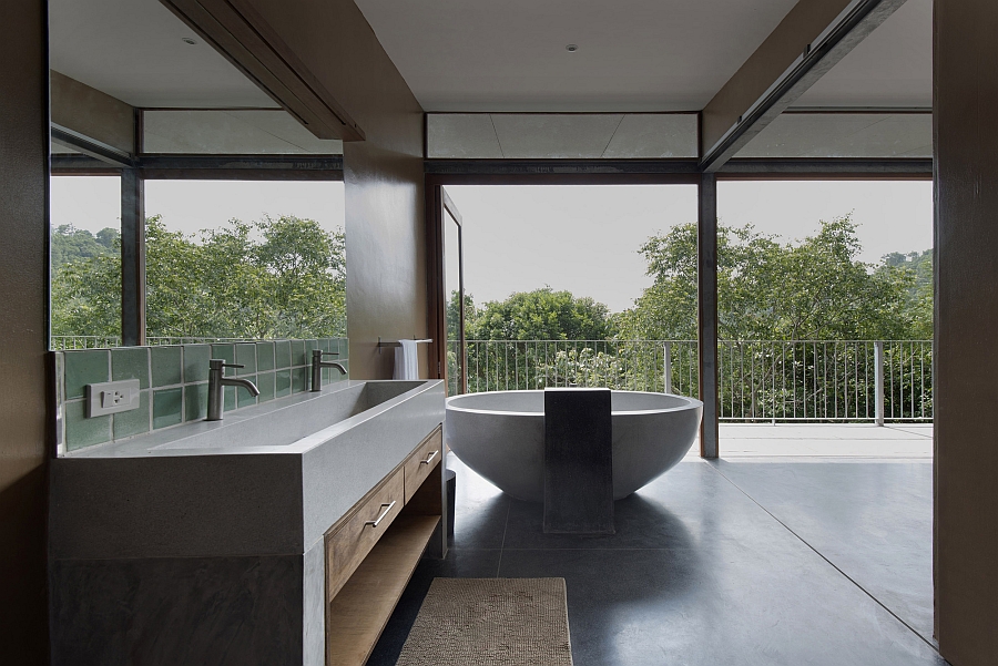 Modern bathroom with standalone tub and a view of the outdoors