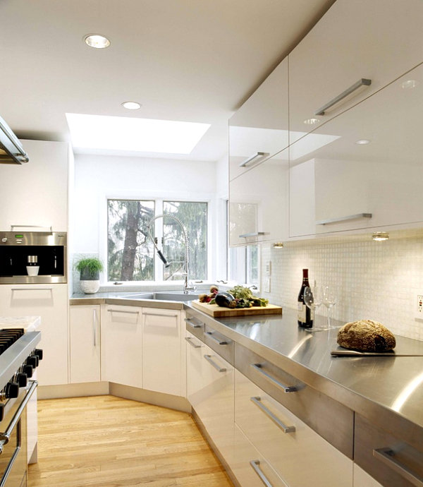 Modern white kitchen with stainless steel countertops