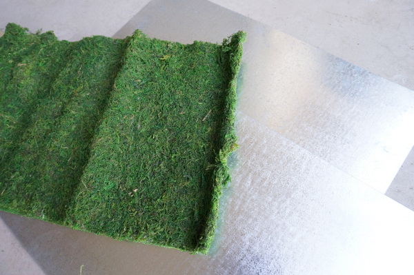 Moss and sheet metal are the supplies of choice for this outdoor DIY wall art