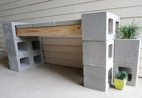 Plants at the base of a cinder block bench