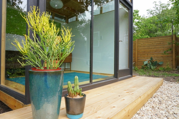 Potted succulents rest on the cedar deck