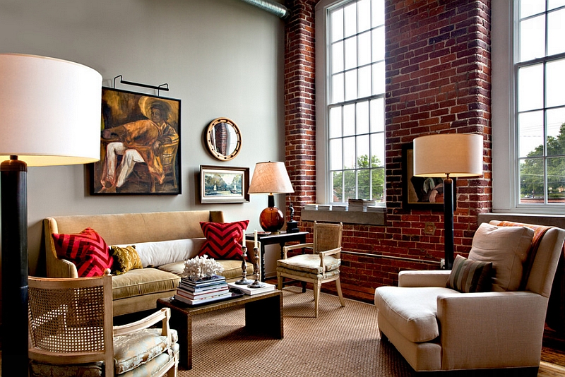 Red chevron pattern pillows complement the exposed brick wall of the eclectic home