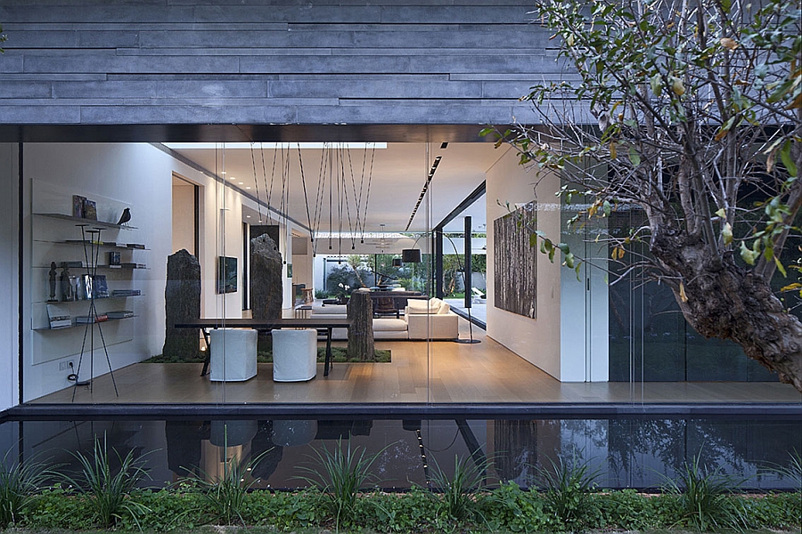 Reflective water body gives the home the appearance of floating on water