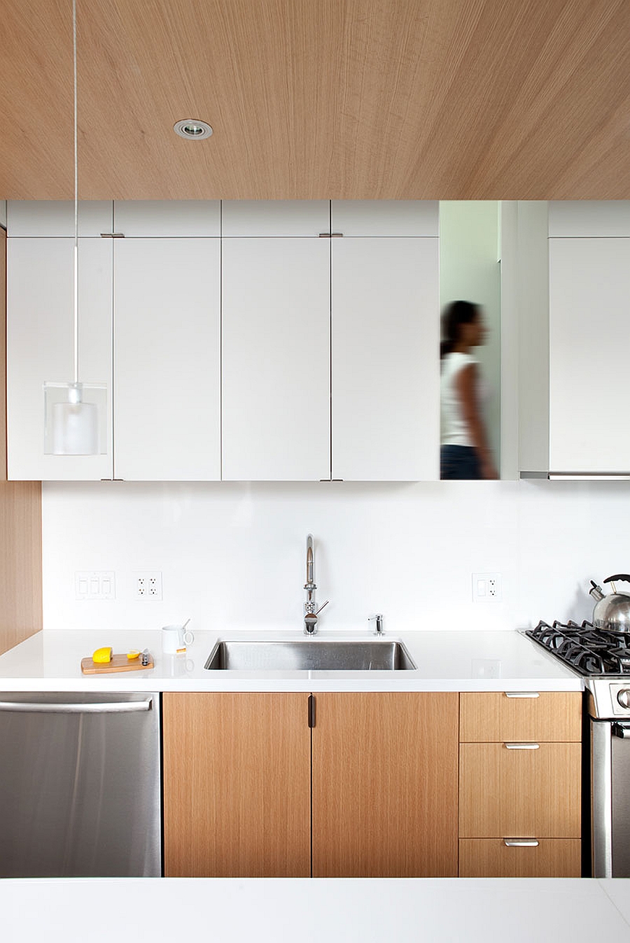 Sleek, modern kitchen in white with wooden cabinets