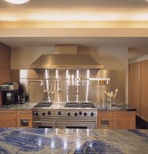 Stainless steel backdrop in a kitchen with blue countertops