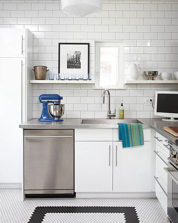 Stainless steel countertops and white subway tile in a modern kitchen