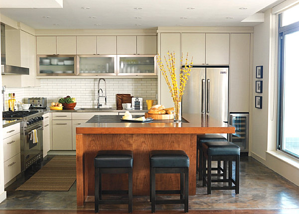 Stainless steel countertops in a white kitchen with warm details