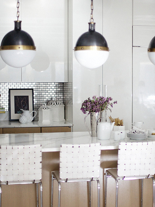 Stainless steel tile backsplash in a white kitchen with metallic accents